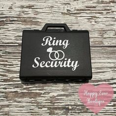 a black case with the words ring security on it and a pink heart in front