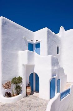 a white building with blue doors and windows