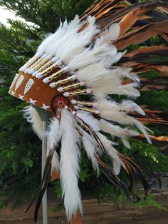 Short Brown Indian Headdress Replica made with rooster dyed feathers and shell white work in the front This great adult headdress is entirely handmade and truly adorable. Perfect photography prop for your special ocasion. Ties in the back for a perfect fit. This will be precious for your costume, or even room decor. Head circumference: 59 centimeters / 23 inches ✈️ Worldwide shipping 🐤 I only use authentic feathers ⛺️ I guarantee highest quality, 100% hand-crafted White Bohemian Ceremonial Headpiece, Ceremonial White Handmade Headpieces, Ceremonial Handmade White Headpiece, Handmade White Headpieces For Ceremonial Events, White Headpieces For Carnival Festival, White Bohemian Costume Hats And Headpieces For Festivals, White Bohemian Costume Hat For Festivals, Bohemian White Headpiece For Festival, Perfect Photography