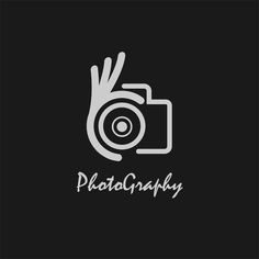 a hand holding a camera with the word photography written on it in white lettering, against a black background