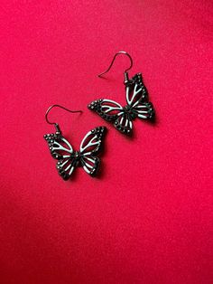 Spread your wings and fly into beautiful style with new jewelry from Cosmic Created Magic! Hanging from hook black earrings is an exquisite hollow butterfly. The body and outer edges of the butterfly wings is a rich matte black with sparkly black rhinestones. The wings of the butterflies are a glossy light blue. These gorgeous earrings are going to look so great on you! Black Butterfly Charm Jewelry, Handmade Black Butterfly Jewelry, Spread Your Wings And Fly, Beautiful Style, Black Earrings, Black Rhinestone, Butterfly Earrings, Blue Butterfly, Butterfly Wings