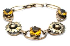 Antique Bracelet - This is a 12K gold filled over sterling silver citrine rhinestones flower bracelet. It is signed PR. ST. CO for Providence Stock Co., hallmarked 1/20 12K on Sterling, 6.25" long, slightly over .5" wide, weighs 8.6 grams. Art Deco Flower, Antique Bracelets, Rhinestone Bracelet, Flower Bracelet, Citrine, Gold Filled, Gold Bracelet, Art Deco, Charm Bracelet