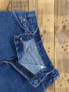 "High waisted 90's denim shorts. Made by Levi's in light dark denim wash. Shorts are in excellent clean condition. Perfectly worn in with light naturally distressed character. These have been cut off and washed once. Measurements are taken zipped or buttoned up and laid comfortably flat then x 2 for total circumference (inches) Levis 550 Tag Size 34 100% Cotton Waist 33\" Hips 45\" Length 14\" Inseam 2.5\" Rise 12.5\" leg opening circumference 25.5\" All items are free of rips, tears, holes, and Vintage Medium Wash Straight Leg Shorts, Dark Wash Rigid Denim Jean Shorts With Pockets, Dark Wash Jean Shorts With Pockets In Rigid Denim, Dark Wash Recycled Denim Cutoff Bottoms, Vintage Denim Blue Straight Leg Jean Shorts, Dark Wash Straight Leg Rigid Denim Shorts, Vintage Dark Wash Straight Leg Shorts, Vintage Straight Leg Dark Wash Shorts, Dark Wash Straight Leg Denim Shorts