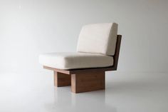 a wooden chair with a white cushion on it