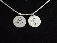 "A tiny sun and moon charm come together on this simple necklace to remind you to Live by the Sun and Love by the Moon. Each charm is handcrafted from fine silver and they come on your choice of 16\", 18\" or 20\" sterling silver box chain. The charms measure 1/2\" each, they hang independently and will move when worn. The necklace will be gift boxed and will ship 3-5 business days after purchase." Sterling Silver Charm Necklace With Sun And Moon Design, Sterling Silver Sun And Moon Pendant Charm Necklace, Sterling Silver Pendant Necklace With Sun And Moon Design, Silver Moon Charm Necklace With Sun And Moon Design, Bohemian Sterling Silver Moon Charm Necklace, Sterling Silver Moon Charm Necklace For Everyday, Dainty Sterling Silver Moon Phase Charm Necklace, Bohemian Sterling Silver Necklace With Moon Charm, Everyday Sterling Silver Charm Necklace With Moon Charm