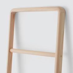 a wooden ladder leaning against a wall with no one on it's back legs