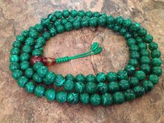 This full mala 108 beads prayer mala is made by malachite beads. This mala is used for meditation purposes or can always be used as necklace or bracelet by wrapping around your wrist. The length of the mala is about 35 inches and bead size about 7-8mm. Beads are strung on a durable nylon cord. This mala can be used both as bracelet by wrapping around your wrist or as a necklace. Malachite prayer bead malas provide powerful grounding energy that clears obstructions and blockages and helps avert c Large Jade Beads For Jewelry Making, Beaded Malachite Round Bead Necklaces, Adjustable 108 Beads For Jewelry Making, Malachite Jewelry With 8mm Round Beads, Green Spiritual Beads For Healing, Green Mala With 8mm Beads For Healing, Green Spiritual Beads, 108 Count, Green Gemstone Beads Mala For Healing, Polished Jade Beads For Spiritual Use