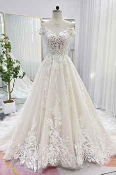 a wedding dress on display in front of a mirror