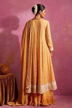 Saffron georgette anarkali with lucknowi thread and sequins embroidery. Comes with sharara and a dupatta. - Aza Fashions