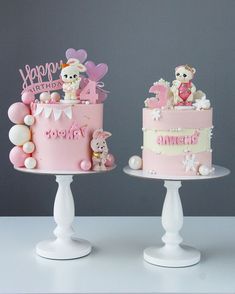 two cakes decorated with teddy bears on top of each other, one is pink and the other is white