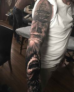 a man with a shark tattoo on his arm