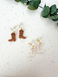 These cowboy boot earrings dangle from a shiny gold star- a necessity for any cowgirl with western style! Choose white or brown. Earrings measure approximately 1.25 inch3w in length and .75 inches in width and are lightweight. Hand sculpted polymer clay earrings, crafted delicately and finished with attention to detail. Hypoallergenic nickel-free posts, hoops, hooks, and silicone backs are used on all pieces.  Due to their handmade nature, colors and textures will vary slightly with each piece. Cowboy Boot Polymer Clay Earrings, Cowboy Polymer Clay Earrings, Western Style Earrings For Gifts, Cowboy Boot Earrings, Cowgirl Earrings, Boot Earrings, Clay Inspo, Earrings Western, Nature Colors