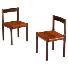 two wooden chairs sitting next to each other