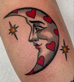 a close up of a person's arm with a crescent moon and hearts on it