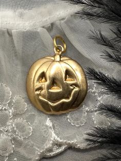 GREAT FOR YOUR CHARM NECKLACE! A HAPPY JACK O LANTERN! These charms are new and unworn, made from decades old stamping machines. Lightweight and can be worn a variety of ways including as a pendant, earrings, on a bracelet, anklet or on a charm necklace. Single sided, hollow back. These charms are made of raw brass which will patina over time and may already have some patina. There may be color variations in the brass due to this.  Please refer to pic with ruler for measurements in inches.  Jump Vintage Gold Jewelry For Halloween, Novelty Jewelry For Halloween Costume, Novelty Halloween Costume Jewelry, Halloween Novelty Jewelry With Charms, Handmade Jewelry For Halloween Costume Party, Fun Nickel-free Jewelry For Halloween, Collectible Gold Jewelry For Halloween, Pumpkin Jack O Lantern, Simple Face