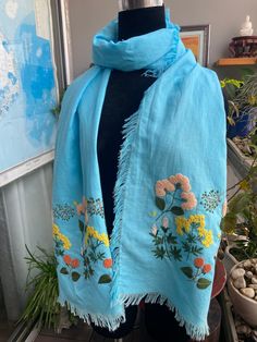 a blue scarf with flowers on it