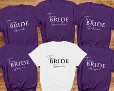 Personalised Hen Party T-shirts. Hen party Tees Bride Tribe, Team Bride, Bridal Party Shirts, Bachelorette T-shirts. Wedding tops Hen Party.  Introducing our fabulous Hen Party T-shirt in Beautiful Purple and white! Made with love from 100% cotton, this tee is the perfect addition to any bride and bridesmaid squad, ensuring you look and feel incredible during all your pre-wedding celebrations.  The bride's shirt is a classic white with a beautiful black print. The other hen party members' t-shirts are a stylish Purple colour with a crisp white print. These shirts are not only fashionable but also practical, as they can be worn by both men and women in your group so can give a relaxed fit feel. - Custom: Each t-shirt is carefully handmade to match your bridal party's unique style. We pay at Cheap T-shirt For Hen Party In Summer, White Fitted T-shirt For Bachelorette Party, White Short Sleeve Top For Bridesmaids, Fitted White Top For Bridesmaid, White Fitted Top For Bridesmaids, White Short Sleeve Top For Bridal Shower, White Short Sleeve Top For Hen Party, Fitted White Top For Bridal Shower, White Fitted Top For Bridal Shower