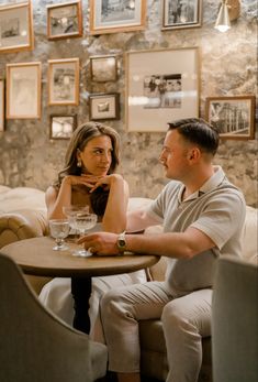 a man and woman sitting at a table in a restaurant