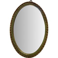 an oval mirror is hanging on the wall