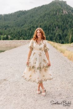 This creamy embroidered dress is so dreamy and the perfect addition to your closet. Featuring flowy sleeves, a wrap style v-neckline and layered skirt. Spring Wedding V-neck Dress With Ruffles, Cream V-neck Dress With Floral Embroidery, Bohemian Dress With Surplice Neckline For Garden Party, Flowy V-neck Embroidered Dress, Spring Wedding V-neck Dress With Surplice Neckline, Cream V-neck Midi Dress For Wedding, Embroidered V-neck Midi Dress For Garden Party, Beige V-neck Dress With Floral Embroidery, Spring Wedding V-neck Dress With Short Sleeves