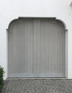 a white building with two large doors on each side