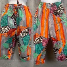 Vintage 1980s Jams Long Shorts. Orange, gray, teal, pink, black and white novelty geometric patchwork print.  Elastic waist with drawstring closure. Hem sits below the knee. Logo patch on the front leg. Two hip pockets. One back pocket with the Jams logo. Excellent vintage condition. The elastic inside the waistband is slightly twisted.  No other noted flaws. Tagged size small. Laid flat and measured. Waist - 16-19 inches  Hips - 20 inches Rise - 12 1/2 inches Length - 27 inches Inseam- 16 inche Multicolor Printed Shorts For Loungewear, Multicolor Printed Loungewear Shorts, Multicolor Casual Bottoms With Retro Print, Casual Multicolor Bottoms With Retro Print, Retro Multicolor Graphic Print Bottoms, Retro Multicolor Bottoms With Graphic Print, Retro Multicolor Printed Bottoms, Retro Multicolor Bottoms With Patchwork, Retro Multicolor Patchwork Bottoms