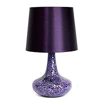 a purple table lamp sitting on top of a white floor next to a black shade