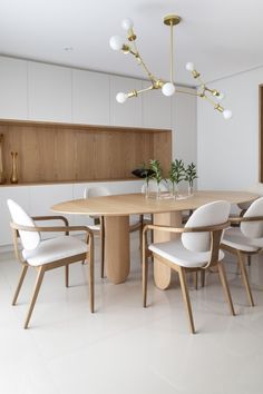 a dining room table with white chairs around it