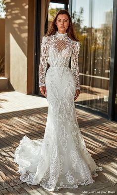 a woman in a wedding dress standing outside