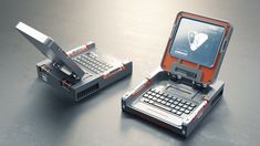 an open laptop computer sitting on top of a metal table next to a keyboard and mouse