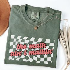 a t - shirt that says we math and i'm native next to some feathers