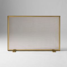 a white screen with gold trim on the bottom and sides, in front of a gray background