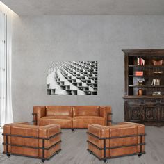 a living room filled with furniture and a painting on the wall