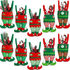 christmas stocking holders with stockings and candy canes in them, all decorated to look like elves