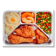 a tray with chicken, carrots, peas and mashed potatoes