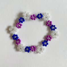 Handmade bracelet. Made with elastic nylon thread. Handmade Purple Flower Beaded Bracelets, Adjustable Purple Flower Beaded Bracelets, Purple Flower Bracelets For Friendship, Adjustable Purple Beaded Wristband, Casual Handmade Purple Stretch Bracelet, Beading Tutorials, Handmade Bracelet, Handmade Bracelets, White Blue