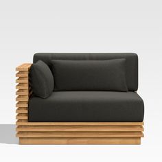 a black couch sitting on top of a wooden frame