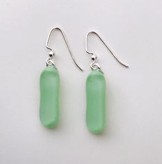 Mint Green Extra Long Fused Glass Dangle  Earrings Perfect for adding that POP of colour to any outfit. a gorgeous soft mint green base with a clear top to add some extra shine.  Each pair of earrings is created in my home studio and kiln fired. Earrings may vary slightly in size and contain small air bubbles which are characteristics of kiln fused glass. No two pairs are ever the same, making them a one of a kind pair of wearable art! Please note you are not purchasing the exact pair of earring Green Dangle Earrings With Recycled Glass, Green Dangle Earrings In Recycled Glass, Green Recycled Glass Dangle Earrings, Minimalist Green Teardrop Earrings, Modern Green Glass Earrings, Soft Mint Green, Soft Mint, Clear Top, Long Dangle Earrings