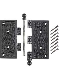 two black iron door handles with screws on each side and one has an ornate design