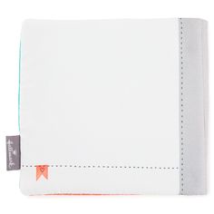 a white cloth with orange stitching on the front and back side, folded in half