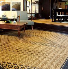 a living room filled with lots of furniture next to a wooden floor covered in rugs