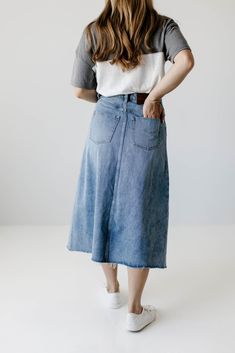 With a high waist, classic wash, and a raw edge hem, the 'Brooke' A-Line Denim Skirt is bound to become a favorite in your denim collection! It is a true high waisted skirt designed to be worn high at the smallest part of the waist while the hem flares out for a flattering fit. We love the lived in look of this no-stretch midi denim skirt! Wear it casual with white sneakers and a tee or pair it with a classic button down for a chic vintage style! 100% Cotton A-Line Fit No-Stretch Hand Wash Cold, High Waist Medium Wash Cotton Denim Skirt, High Waist Medium Wash Denim Skirt, High Rise Cotton Denim Skirt With Frayed Hem, Denim Bottoms With Unfinished Hem In Dark Wash, Dark Wash Denim Bottoms With Unfinished Hem, High Rise Bottoms With Unfinished Hem For Spring, Spring Dark Wash Bottoms With Unfinished Hem, High Rise Cotton Skirt In Medium Wash, Denim Skirt In Medium Wash