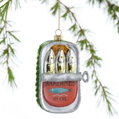 a christmas ornament hanging from a tree with fish in it's mouth