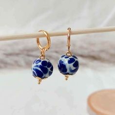 We combine art and elegance to create this beautiful piece. Our handmade earrings will be the perfect element to make your outfit standout. You could have the entire collection or gift them to someone special.  Material: Real Gold plate brass, Talavera gemstone  Dimensions: Drop Length 3cm, weight 2g Features : Lightweight, Unique and Simple design The Talavera of Puebla is part of the intangible heritage of humanity, declared by UNESCO. It is a type of majolica ceramic with a mixture of Chinese, Italian, Spanish, and indigenous techniques, and its colors are obtained from natural pigments. Its main characteristics are its vitreous finish and the use of bulky cobalt blue, this made it even more exclusive and ostentatious than Spanish craftsmanship. Its production requires at least 120 hour Handmade Bohemian 14k Gold Filled Earrings, Handmade 14k Gold Filled Bohemian Earrings, Unique Round Bead Earrings As Gift, Unique Round Beads Earrings For Gift, Artisan Dangle Earrings As Gift, Artisan Dangle Earrings For Gift, Artisan Drop Earrings As Gift, Handmade Artistic Earrings With Round Beads, Artistic Handmade Earrings With Round Beads