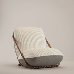 an upholstered chair with wooden legs and a cushion on the back is shown in front of a gray background