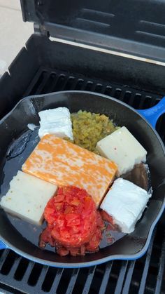 a pan filled with different types of food on top of an open grilling pan