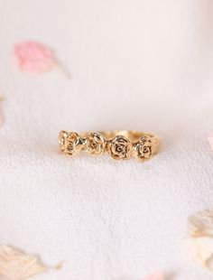 This hand-carved band features a halo of rosebuds, designed to enrapture you within the Divine love of your angels and serve as a reminder of your innate perfection and beauty. Available in 14k Yellow, Rose or White Gold No Stones Roses have long been cherished and sacred within my heart. My birth-month flower, fondest fragrance in its gentility, the color most representative of my soul’s auric field, I seek to discover more roses each time I return to Paris - kept illuminated within the stained Elegant Promise Jewelry With Rose Design, Rose Gold Wedding Jewelry With Rose Details, Rose Gold Wedding Jewelry With Roses, Dainty Rose Jewelry For Anniversary, Dainty Rose Detailed Jewelry For Anniversary, 14k Gold Rose Design Ring, Rose Design Fine Jewelry For Wedding, Delicate Rose Jewelry For Wedding, Adjustable Rose Jewelry For Anniversary