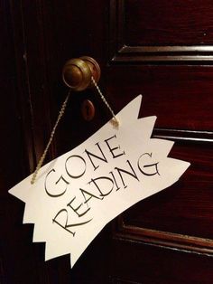 a wooden door with a sign that says gone reading