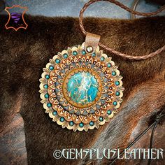 Handmade Southwestern Medallion Necklaces, Bohemian Leather Pendant Necklace, Southwestern Style Hand Tooled Necklace As Gift, Artisan Jewelry With Patina Round Pendant, Hand-tooled Artisan Jewelry For Festivals, Artisan Hand-tooled Necklace For Gift, Artisan Round Pendant Jewelry With Patina, Artisan Round Pendant With Patina Jewelry, Bohemian Engraved Leather Jewelry