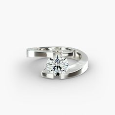 a white gold ring with a single diamond